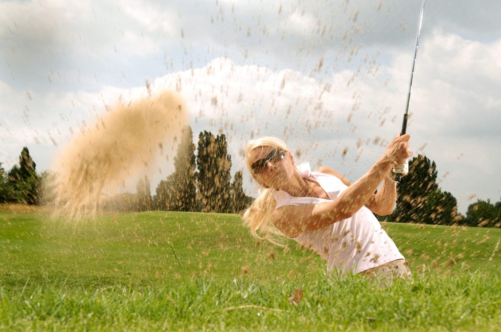 Woman Golfer in a Sand Pit